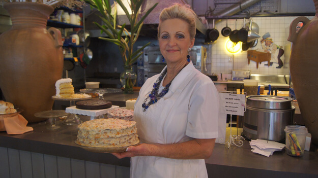 Waitress with kumquat cake at lunch in Limoges